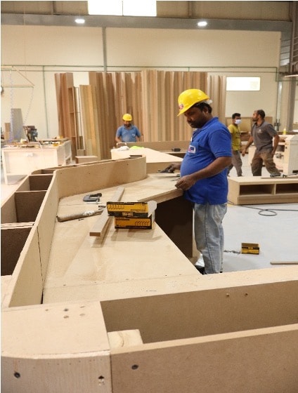 Craftsman performing precision cabinet assembly